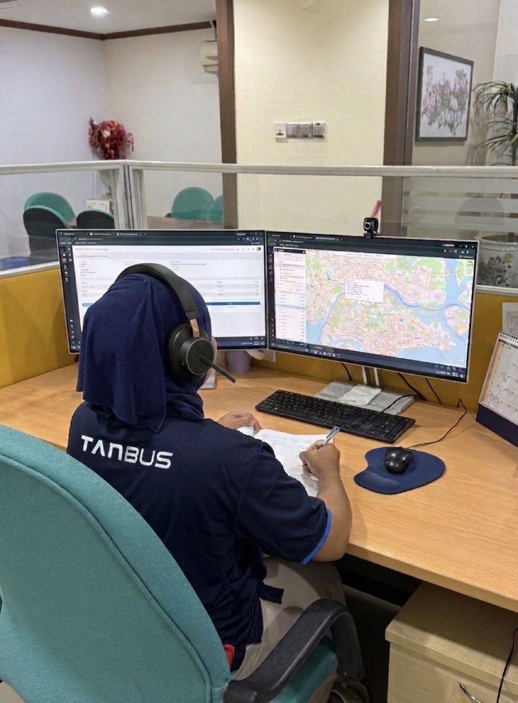 Tan Bus admin and operations staff coordinating routes at the office
