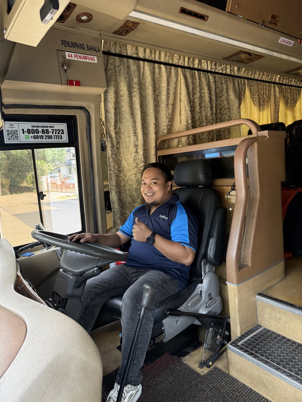 Tan Bus local bus driver in uniform at the wheel
