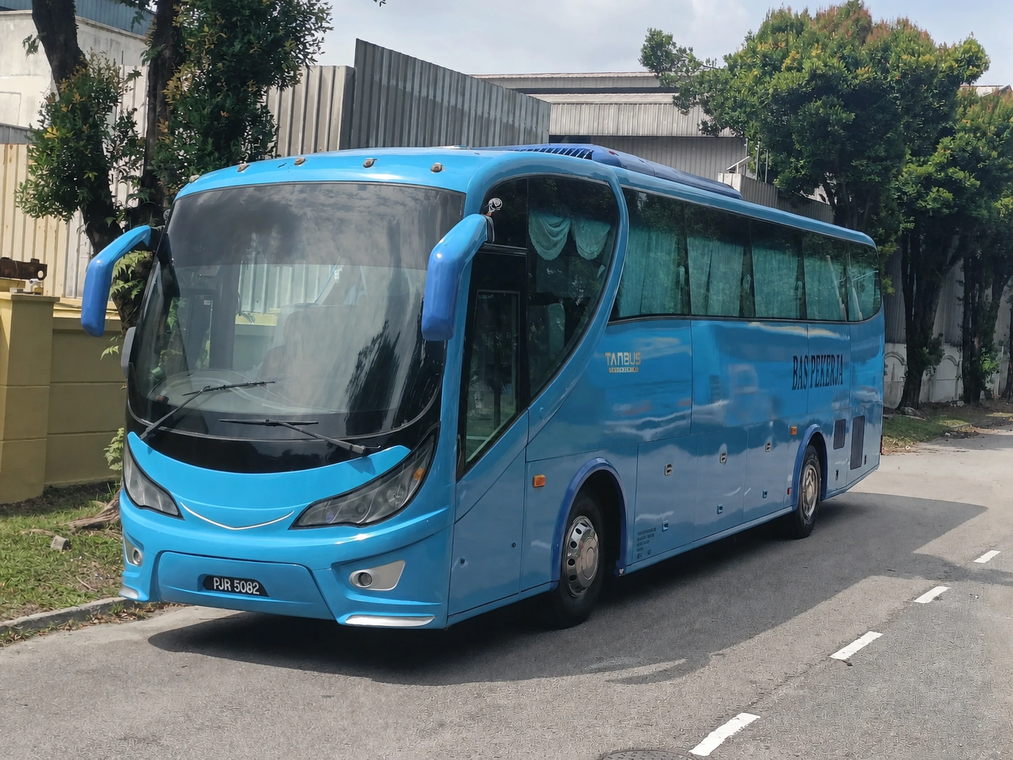 TANBUS worker transport coach with company branding